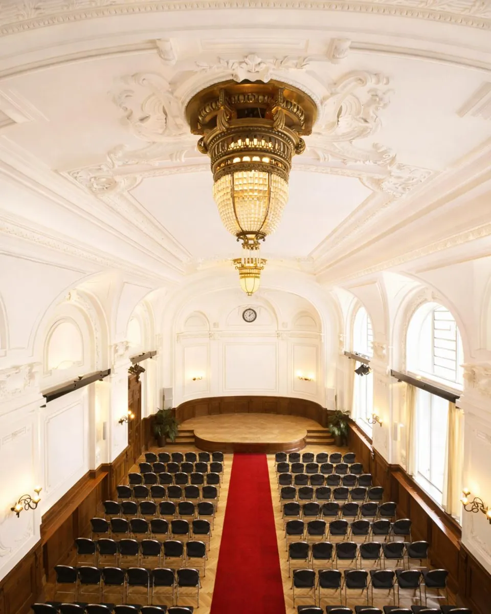 Concert hall of the Albert Hall with chandelier and stucco ceiling
